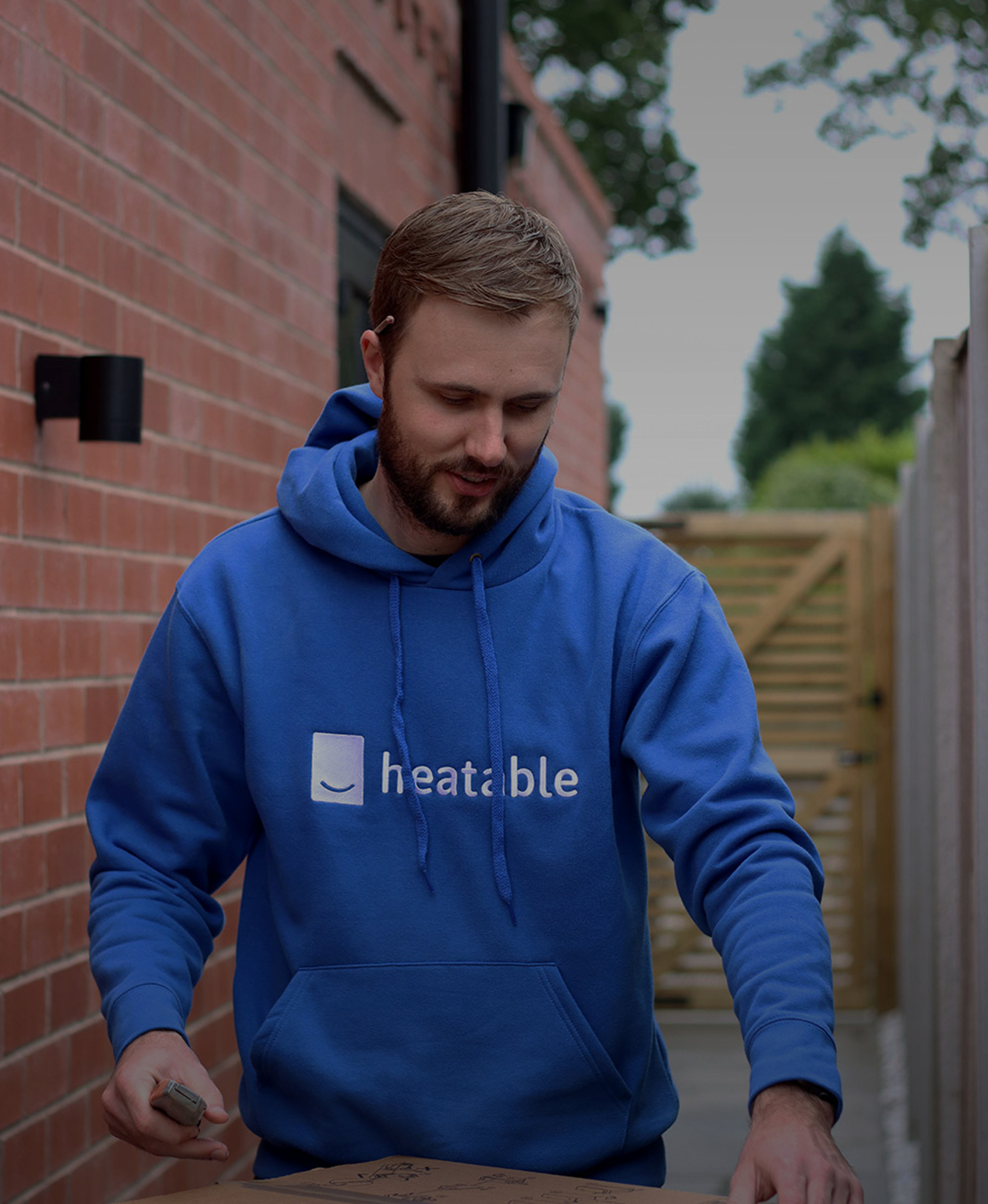 Heatable installer wearing a blue Heatable hoodie
